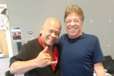 Taboada smiling standing with McElroy during regional training seminar